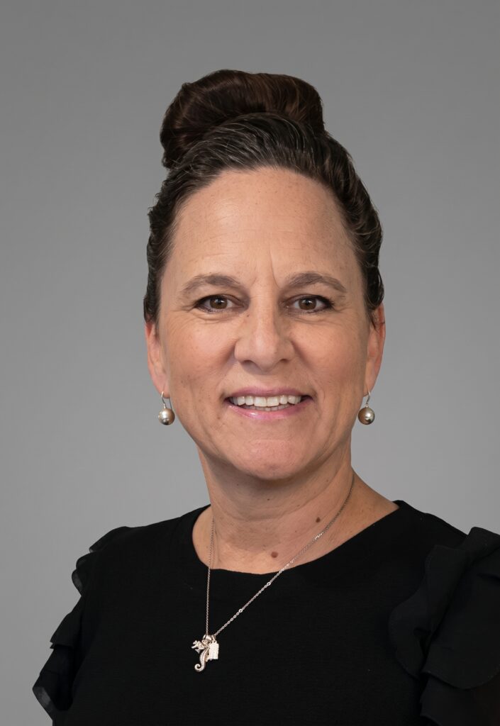 Headshot of women on gray background